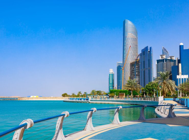 Skyline view of Abu Dhabi panorama with sea, beach and skyscrapers. Sunny summer day in Abu Dhabi - famous tourist destination in UAE. Ideal place for luxury travel and rest