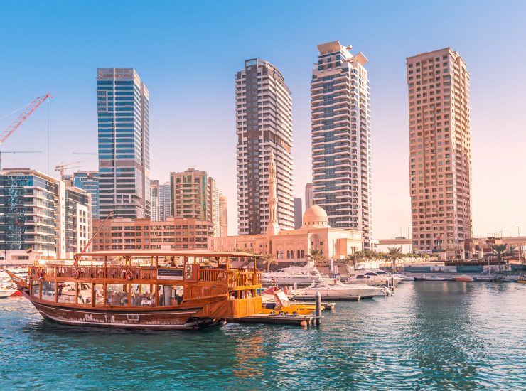 Old-fashioned wooden ferry boat cruise in Dubai Marina harbor. Tourist destinations in United Arab Emirates