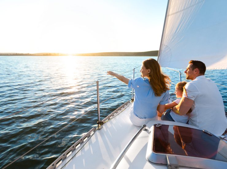Sea Cruise. Family Sitting On Yacht Deck Sailing Across The Sea On Summer Vacation. Panorama, Copy Space