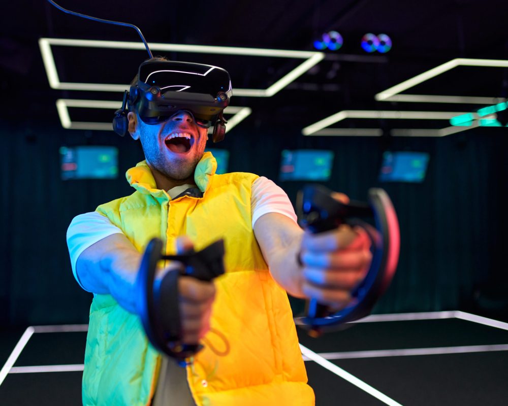 Handsome young man with glasses of virtual reality. VR, games, entertainment, future technology concept.